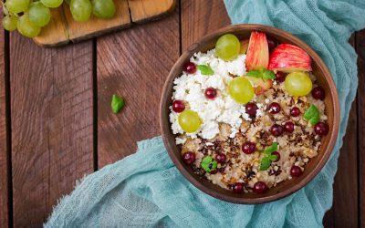 Delicious and healthy oatmeal with grapes, nuts, apples and cottage cheese. Healthy breakfast. Fitness food. Proper nutrition